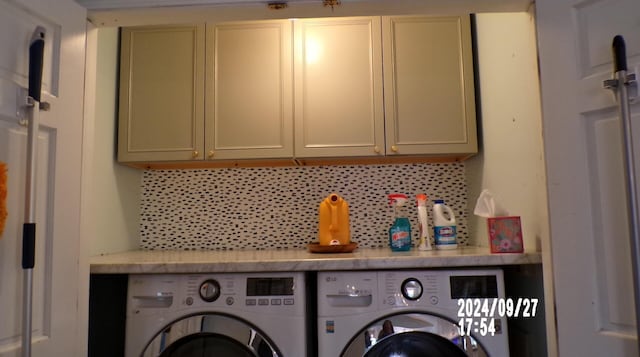 laundry room with cabinets and washing machine and clothes dryer