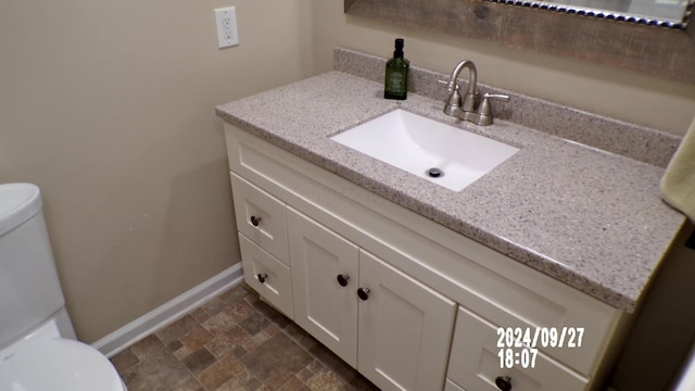 bathroom with vanity and toilet