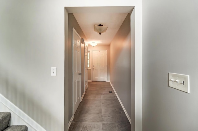 hall featuring tile patterned flooring