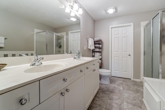 bathroom with vanity, a shower with shower door, and toilet