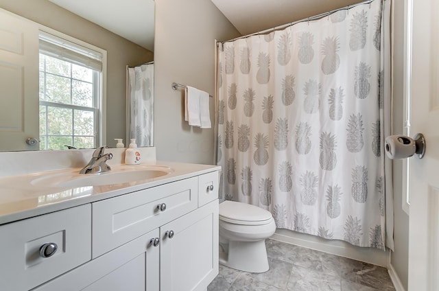 bathroom featuring tile patterned flooring, vanity, and toilet