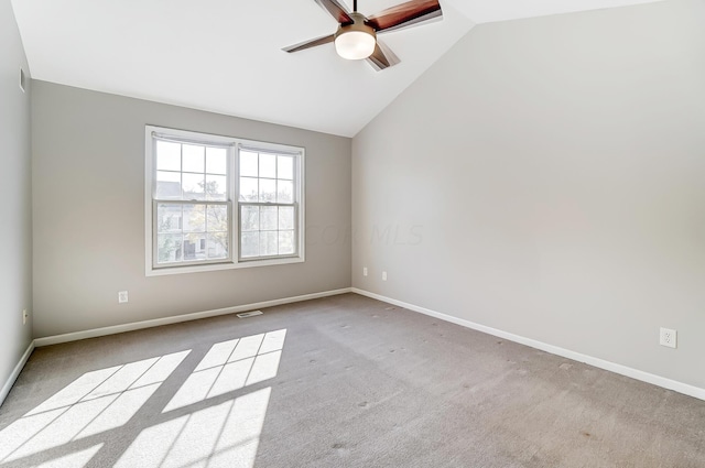 carpeted empty room with ceiling fan and lofted ceiling