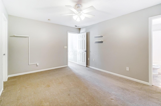 unfurnished room featuring ceiling fan and light colored carpet