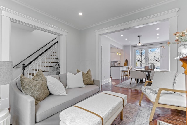 living room with hardwood / wood-style floors and ornamental molding