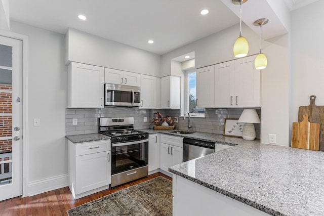 kitchen with sink, white cabinets, and appliances with stainless steel finishes