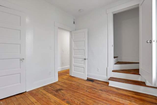 unfurnished bedroom with wood-type flooring