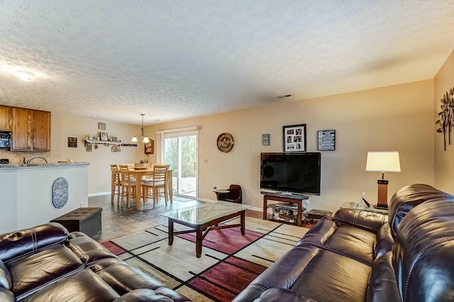 living room featuring baseboards and a textured ceiling