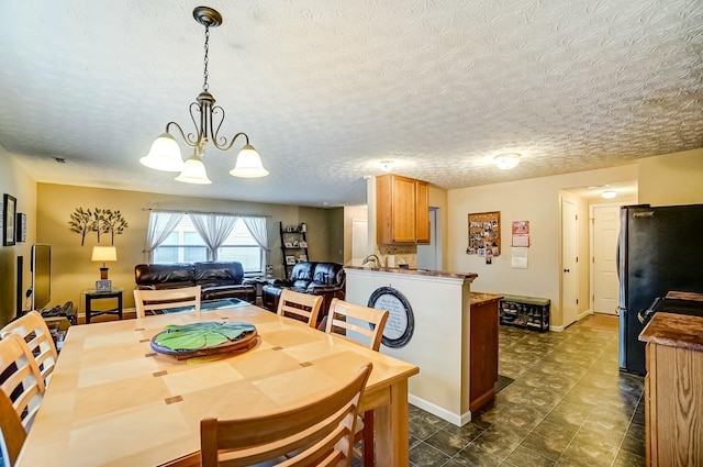 dining room featuring a textured ceiling and an inviting chandelier