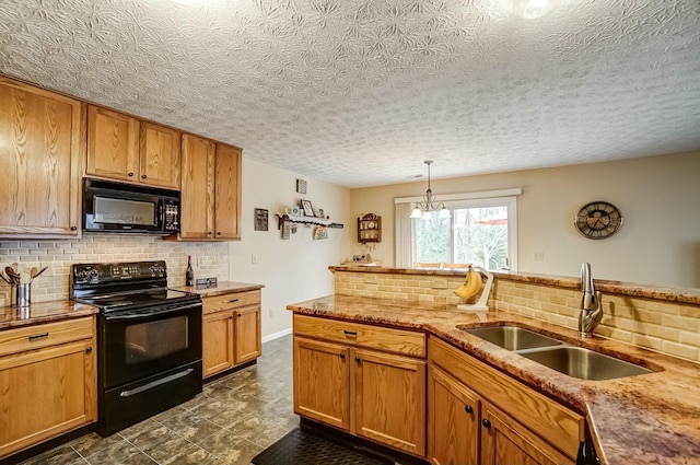 kitchen with brown cabinetry, a sink, black appliances, and tasteful backsplash