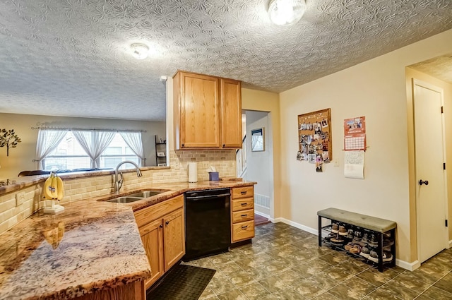 kitchen with dishwasher, baseboards, a sink, and decorative backsplash