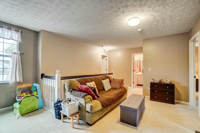 carpeted living room featuring a textured ceiling and baseboards