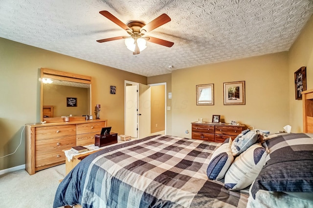 bedroom with a textured ceiling, ceiling fan, baseboards, and light colored carpet