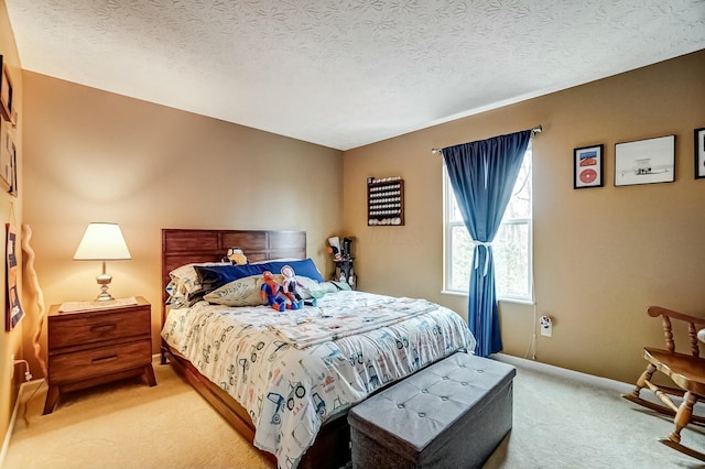 bedroom featuring carpet floors, baseboards, and a textured ceiling