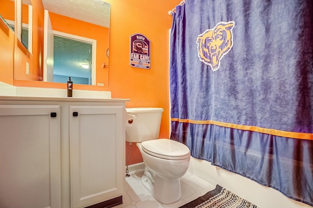 bathroom featuring a textured ceiling, tile patterned flooring, toilet, vanity, and shower / bath combo