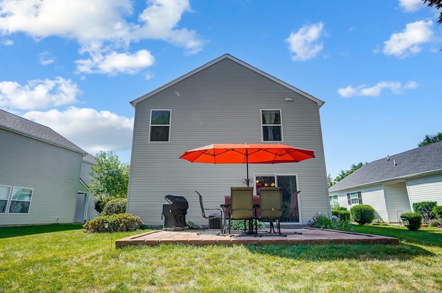 rear view of property featuring a yard and a patio area