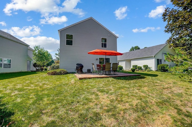 back of property featuring a lawn and a patio area