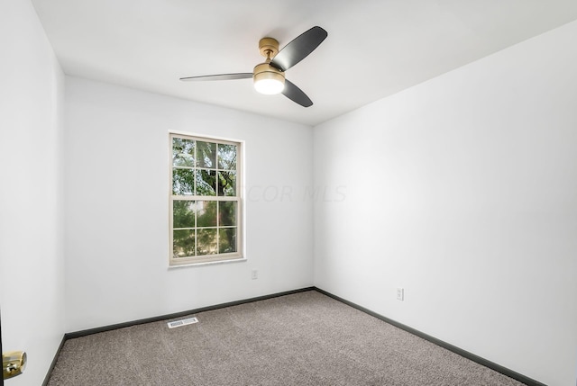 empty room with ceiling fan and carpet floors