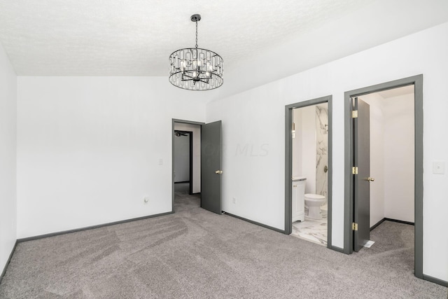 interior space with a textured ceiling, light colored carpet, vaulted ceiling, and a notable chandelier