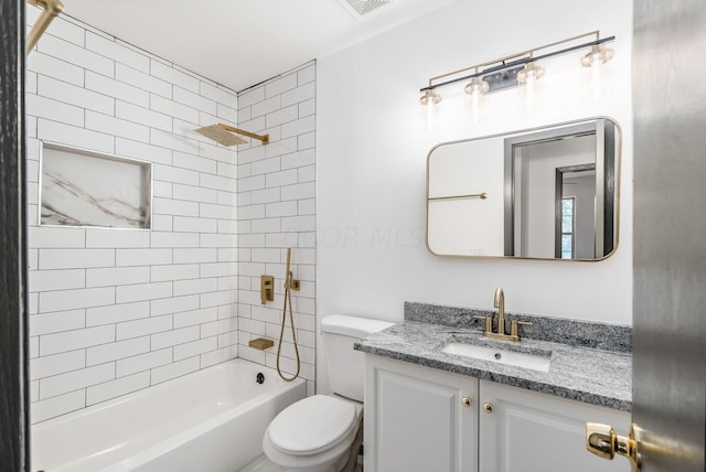 full bathroom with vanity, tiled shower / bath combo, and toilet