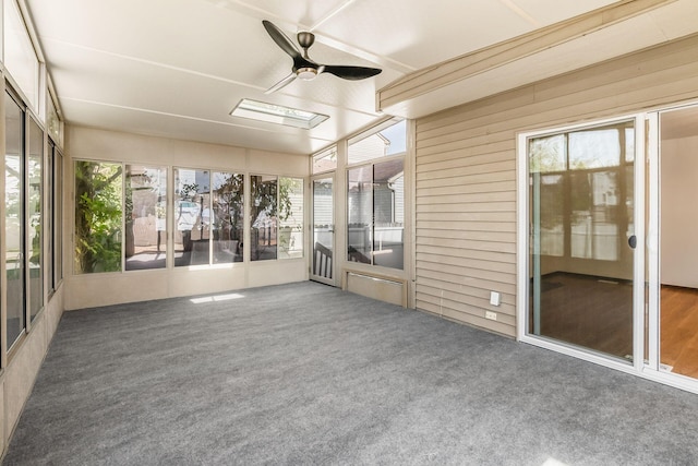 unfurnished sunroom featuring ceiling fan