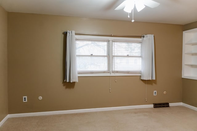 carpeted empty room with ceiling fan