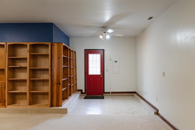 foyer entrance with ceiling fan