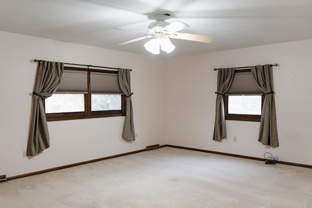 unfurnished room with light carpet and ceiling fan