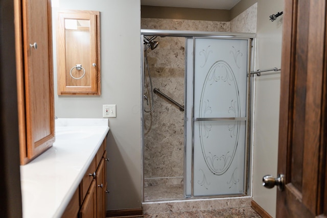 bathroom featuring vanity and a shower with shower door