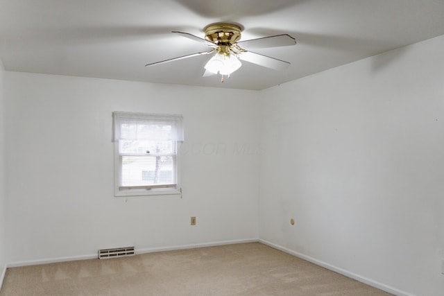 unfurnished room featuring ceiling fan and light carpet