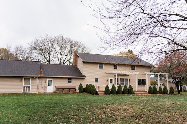 rear view of house with a yard and a pergola