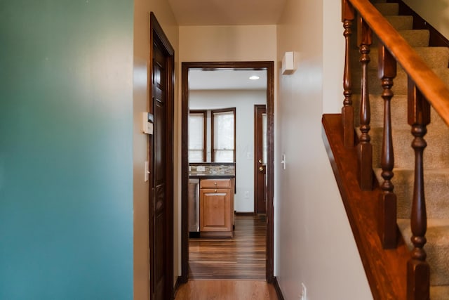 hallway with hardwood / wood-style floors