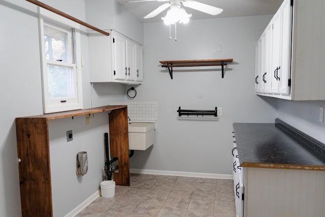 clothes washing area with ceiling fan, cabinets, and electric dryer hookup