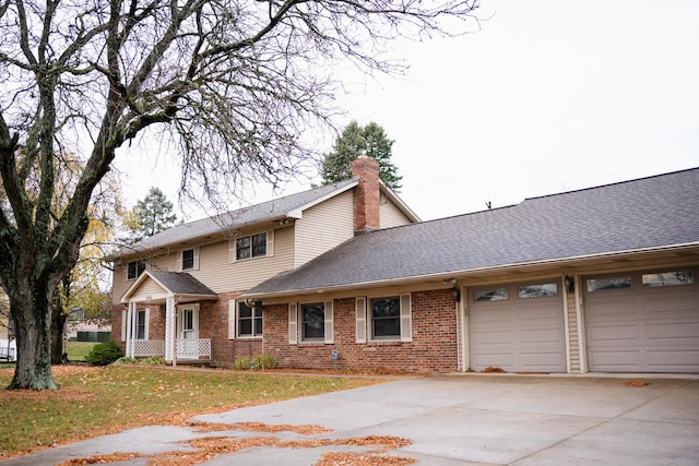 view of front of home with a garage and a front lawn