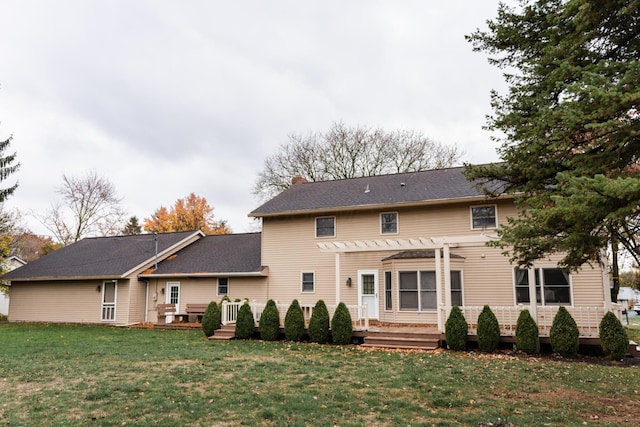 back of property featuring a yard and a pergola