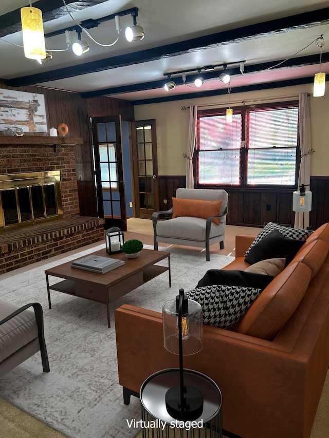 living room with carpet floors, a fireplace, wooden walls, and beamed ceiling