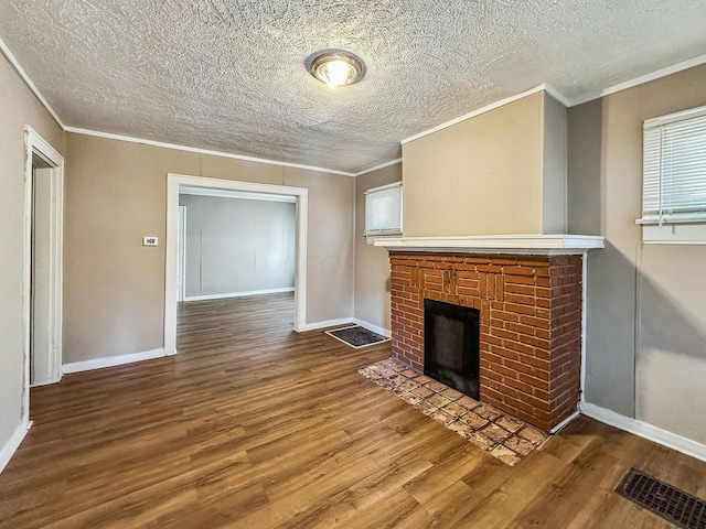 unfurnished living room featuring hardwood / wood-style floors, ornamental molding, a fireplace, and a textured ceiling