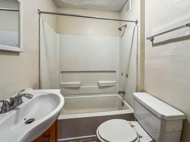 full bathroom with  shower combination, vanity, a textured ceiling, and toilet