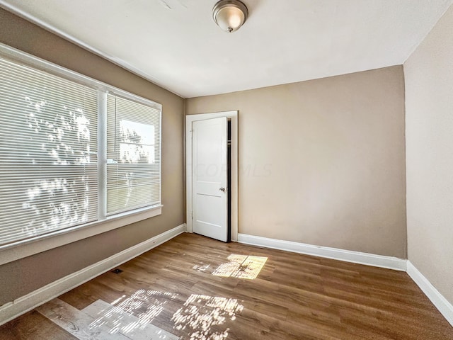 unfurnished room with hardwood / wood-style floors