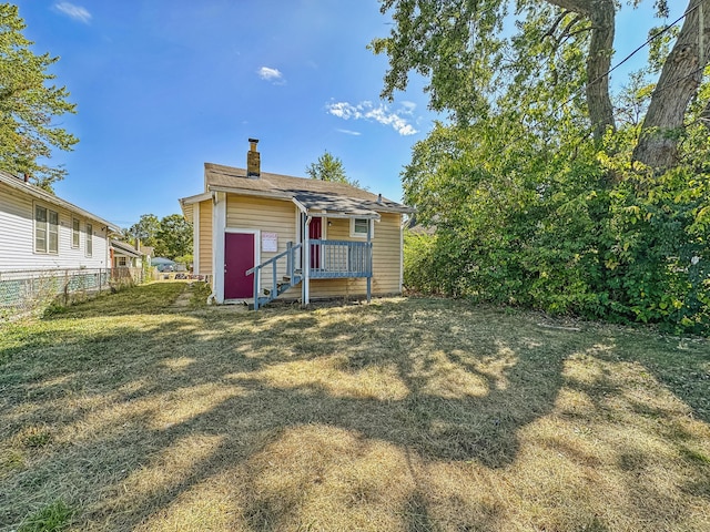 back of house with a lawn