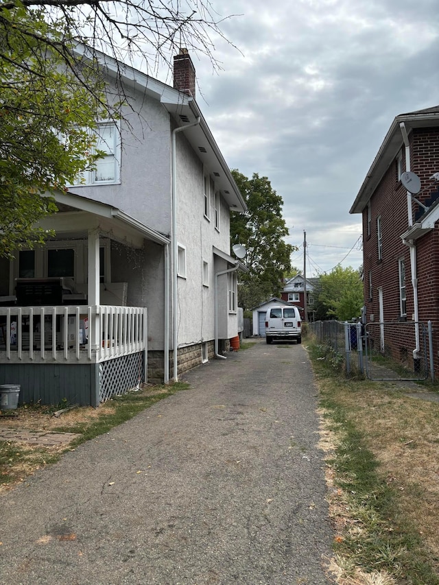 view of side of property featuring covered porch