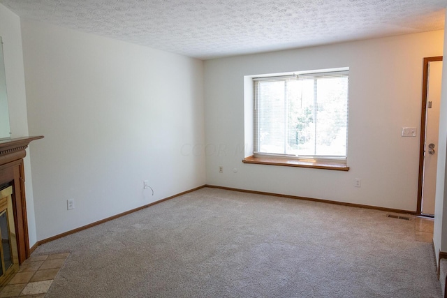 unfurnished living room featuring light colored carpet and a textured ceiling