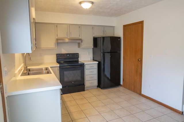 kitchen with black appliances, sink, gray cabinets, light tile patterned floors, and a textured ceiling