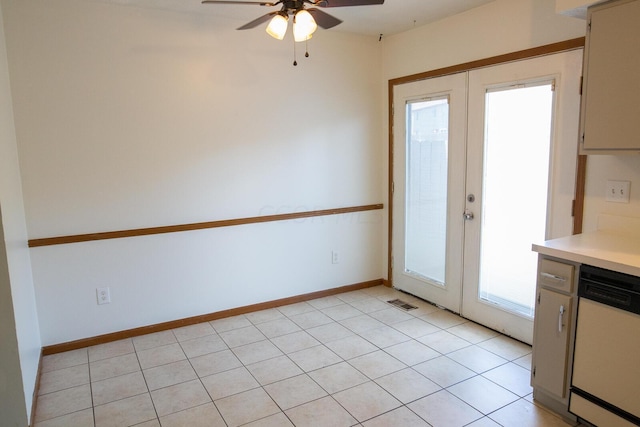 doorway with french doors, light tile patterned floors, and ceiling fan