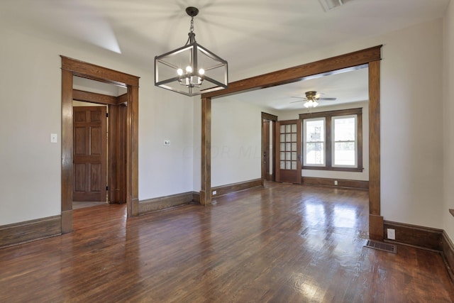 unfurnished room featuring ceiling fan with notable chandelier and dark hardwood / wood-style flooring