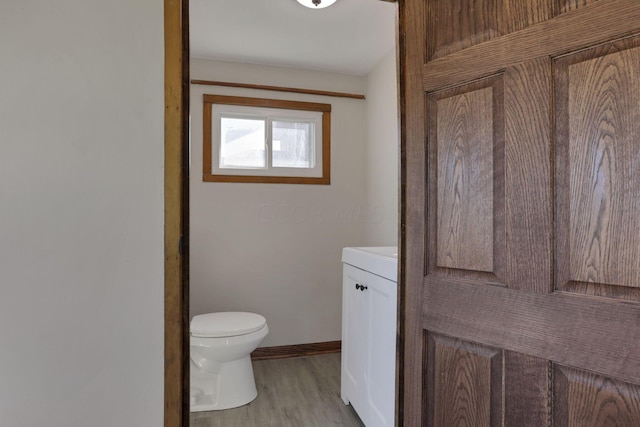 bathroom featuring vanity, toilet, and wood-type flooring