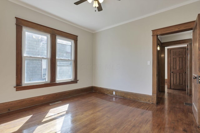 unfurnished room featuring crown molding, ceiling fan, and dark wood-type flooring