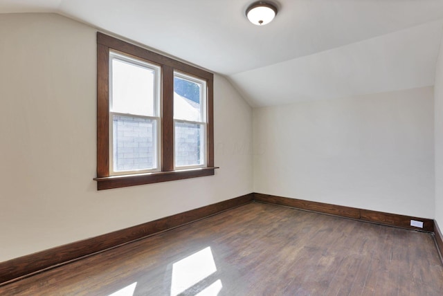 additional living space featuring dark hardwood / wood-style flooring and vaulted ceiling