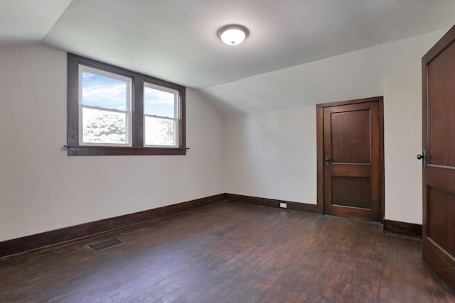 bonus room featuring dark hardwood / wood-style flooring and vaulted ceiling