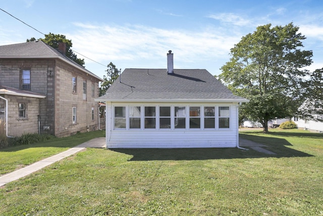 back of property featuring a lawn