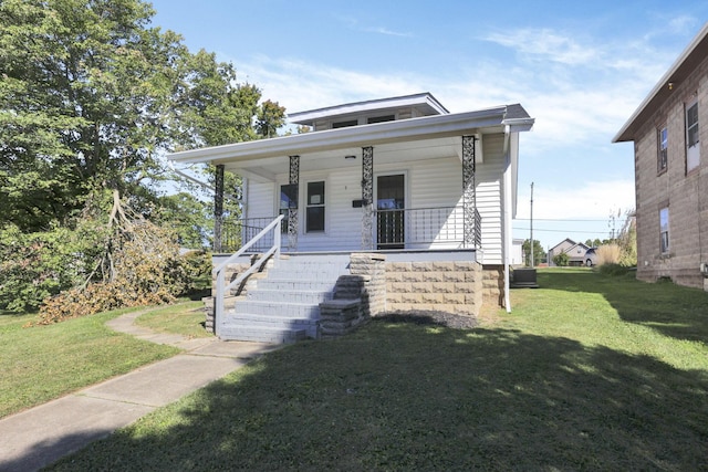 bungalow-style house featuring a porch, central AC, and a front lawn